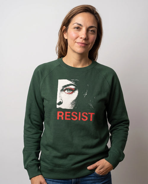 gravisk Resist v1 graphic sweatshirt in organic cotton. Half a face with one open eye, red lashes and the word resist in worn red.