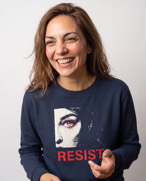 gravisk Resist v1 graphic sweatshirt in organic cotton. Half a face with one open eye, red lashes and the word resist in worn red.