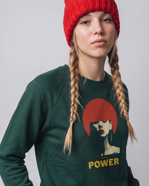 gravisk True Power graphic sweatshirt in organic cotton. Minimal portrait with a red bob and the words true power in gold.