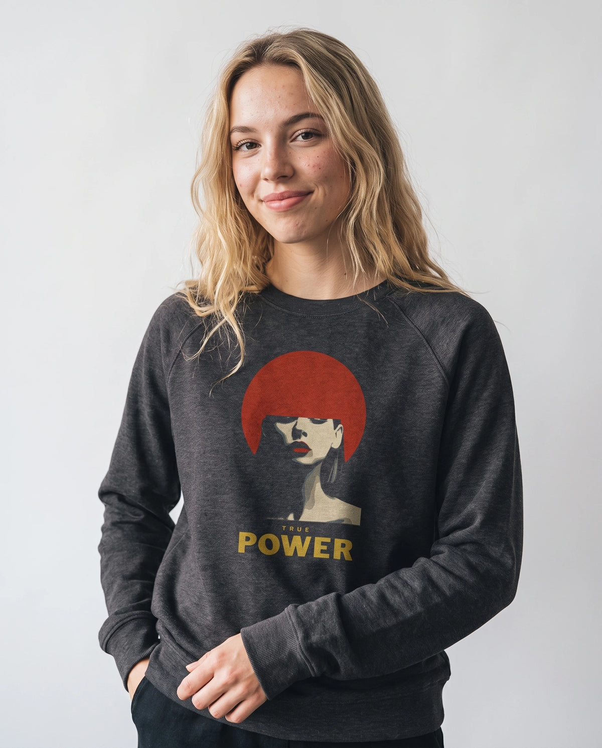 gravisk True Power graphic sweatshirt in organic cotton. Minimal portrait with a red bob and the words true power in gold.