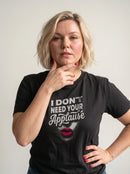 gravisk I Don't Need Your Applause organic graphic tee. A face dissolving into particles, only pink lips intact, Applause in script.