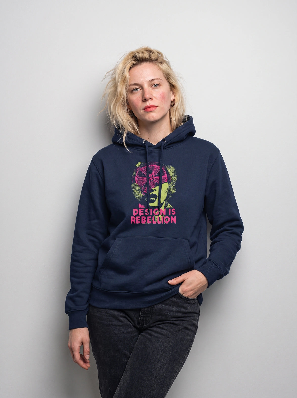 gravisk Design Is Rebellion graphic hoodie in organic cotton. Baroque portrait in acid green with a magenta citrus slice, DESIGN IS REBELLION in hot pink.