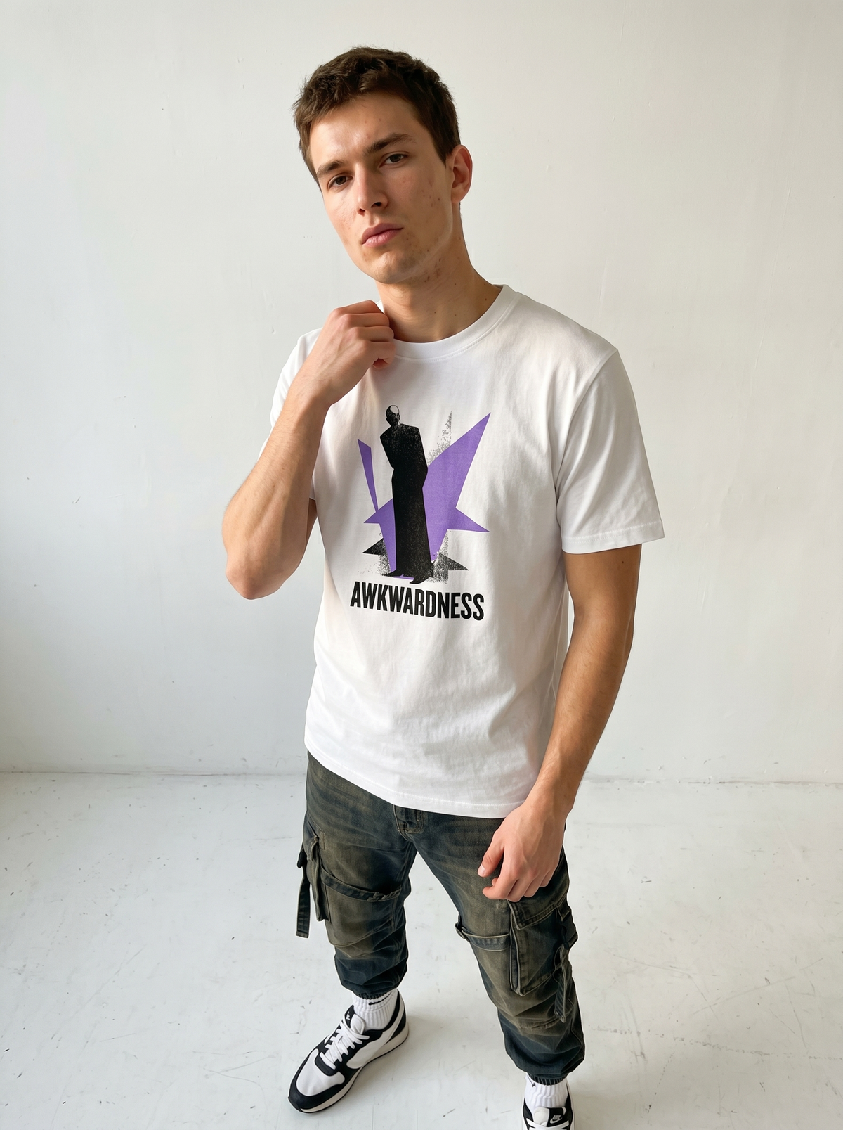 gravisk Awkwardness organic graphic tee. A dark figure in front of a lavender starburst, AWKWARDNESS in black caps below.