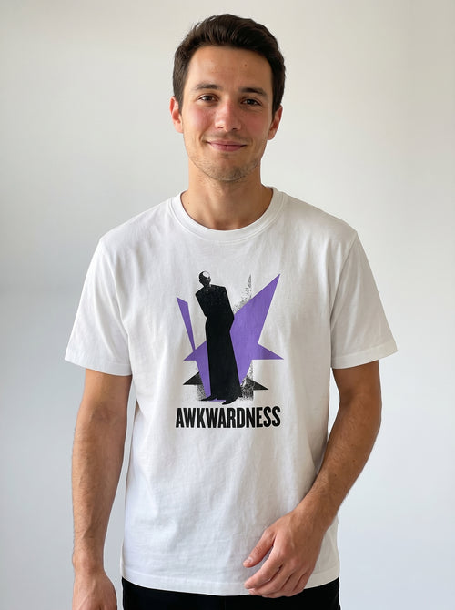 gravisk Awkwardness organic graphic tee. A dark figure in front of a lavender starburst, AWKWARDNESS in black caps below.