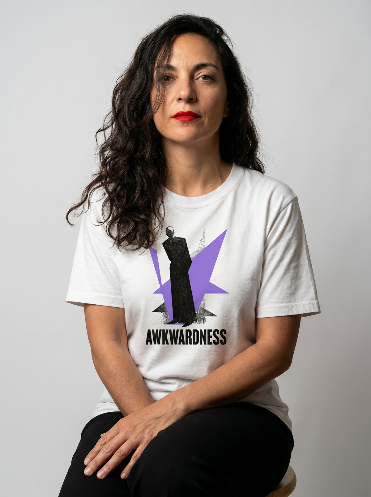 gravisk Awkwardness organic graphic tee. A dark figure in front of a lavender starburst, AWKWARDNESS in black caps below.