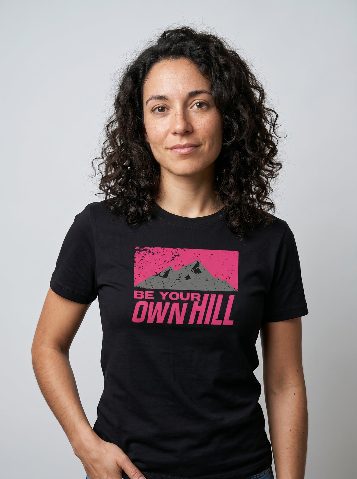 gravisk Be Your Own Hill organic graphic tee. A dark mountain range in a worn magenta field: not the peak, the whole hill.