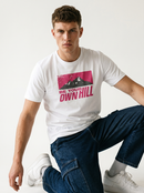 gravisk Be Your Own Hill organic graphic tee. A dark mountain range in a worn magenta field: not the peak, the whole hill.