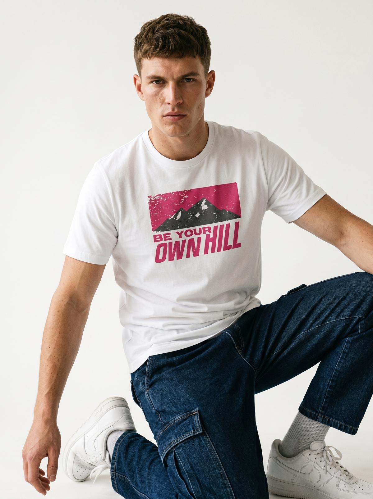 gravisk Be Your Own Hill organic graphic tee. A dark mountain range in a worn magenta field: not the peak, the whole hill.