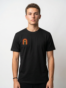 gravisk Bloom Arch organic graphic tee. Left-chest arch in amber and burnt orange, a single flower growing inside.