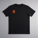 gravisk Bloom Arch organic graphic tee. Left-chest arch in amber and burnt orange, a single flower growing inside.