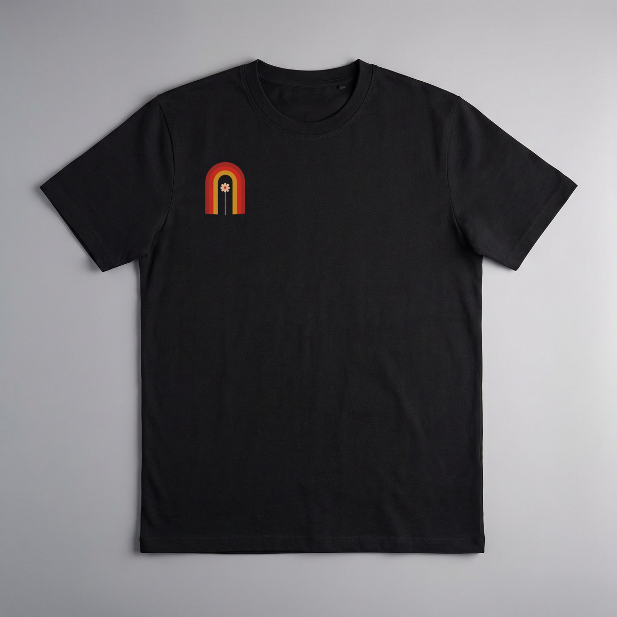 gravisk Bloom Arch organic graphic tee. Left-chest arch in amber and burnt orange, a single flower growing inside.