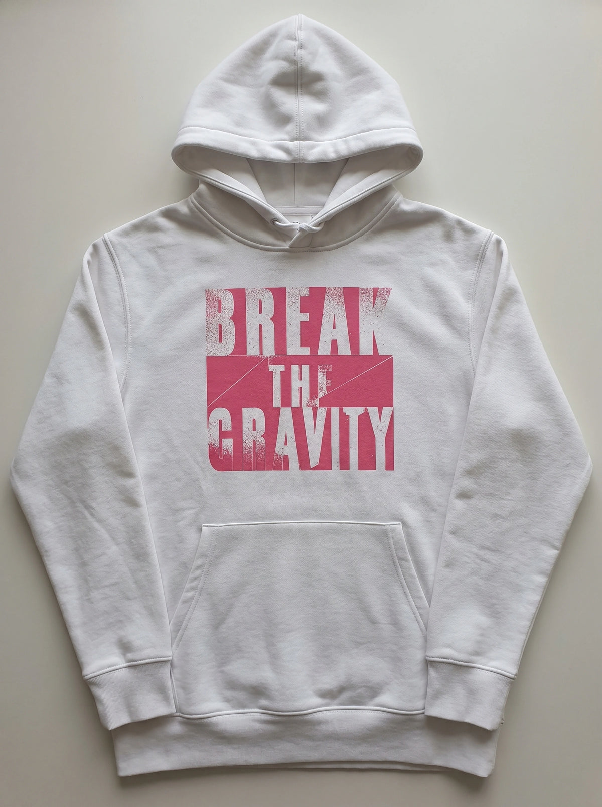 gravisk Break The Gravity graphic hoodie in organic cotton. Heavy pink block letters with torn, sprayed edges.