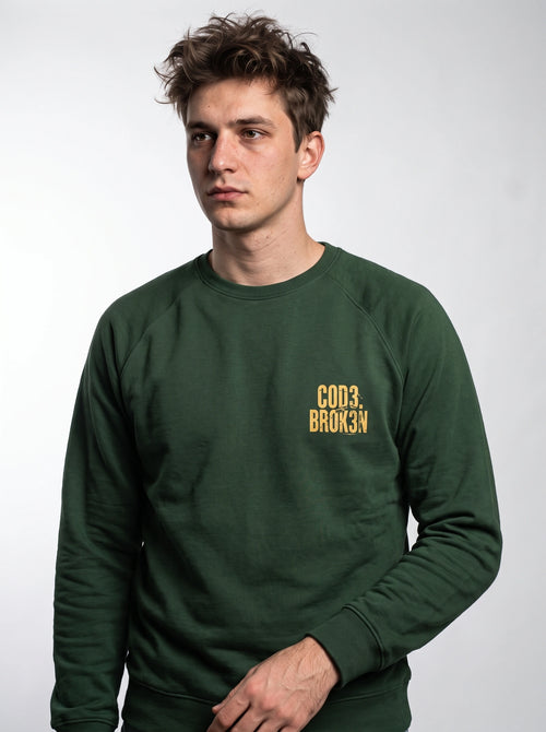 gravisk Code Broken chest print sweatshirt in organic cotton. COD3. BROK3N in small worn gold letters on the left chest.