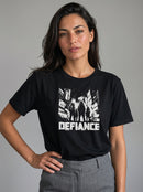 gravisk Defiance organic graphic tee. High-contrast scene of four figures standing their ground in urban ruins.