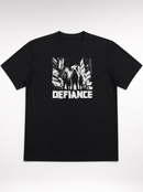 gravisk Defiance organic graphic tee. High-contrast scene of four figures standing their ground in urban ruins.