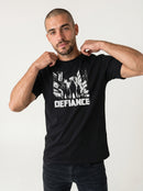 gravisk Defiance organic graphic tee. High-contrast scene of four figures standing their ground in urban ruins.