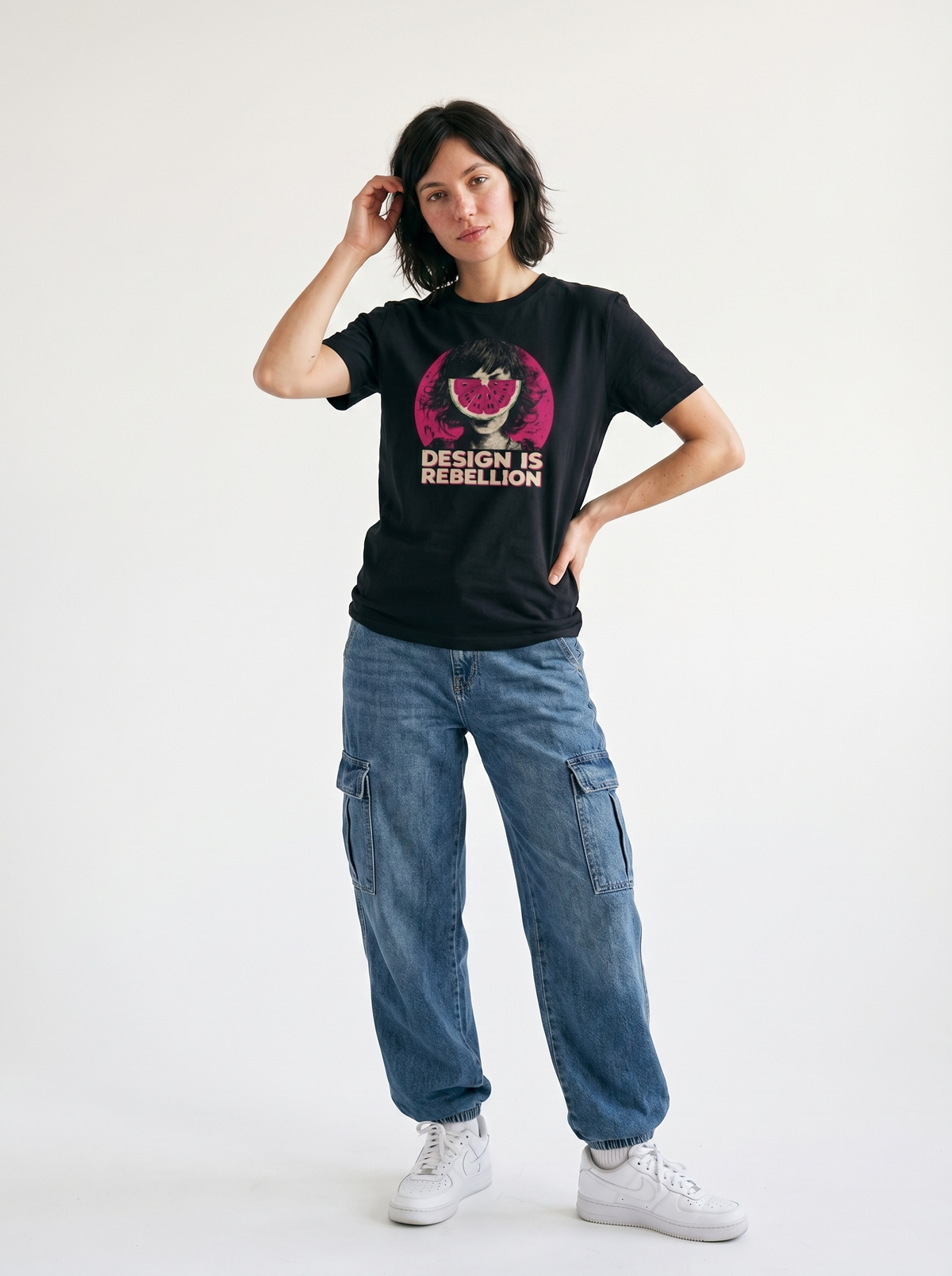 gravisk Design Is Rebellion organic graphic tee. Half-tone portrait with a watermelon mask in a magenta circle.