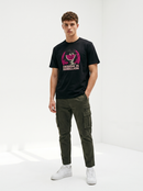 gravisk Design Is Rebellion organic graphic tee. Half-tone portrait with a watermelon mask in a magenta circle.