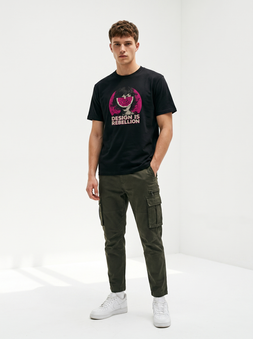 gravisk Design Is Rebellion organic graphic tee. Half-tone portrait with a watermelon mask in a magenta circle.