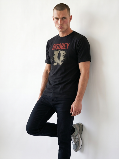 gravisk Disobey organic graphic tee. Distressed red DISOBEY type over a lone figure in an empty street.