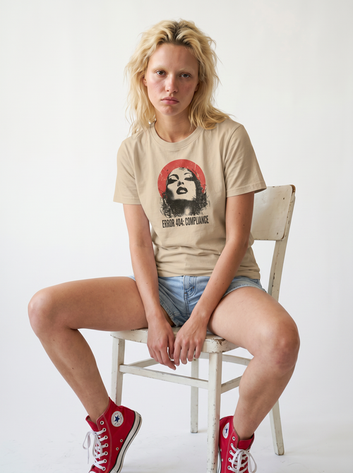 gravisk Error 404: Compliance organic graphic tee. Distressed portrait in a red circle, monospace ERROR 404: COMPLIANCE type.