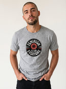 gravisk Feminism Is for Everyone organic graphic tee. Circular emblem with a coral flower and curved FEMINISM IS FOR EVERYONE type.