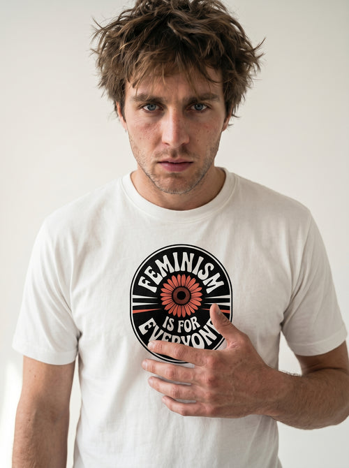 gravisk Feminism Is for Everyone organic graphic tee. Circular emblem with a coral flower and curved FEMINISM IS FOR EVERYONE type.