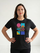 gravisk Feminism Is Freedom organic graphic tee. Bauhaus shapes in pink, teal, yellow and cobalt around cream FEMINISM IS FREEDOM type.
