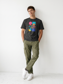 gravisk Feminism Is Freedom organic graphic tee. Bauhaus shapes in pink, teal, yellow and cobalt around cream FEMINISM IS FREEDOM type.