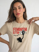 gravisk Feminism Is Fun organic graphic tee. A leaping woman flying a raised-fist kite, red FEMINISM IS FUN type.