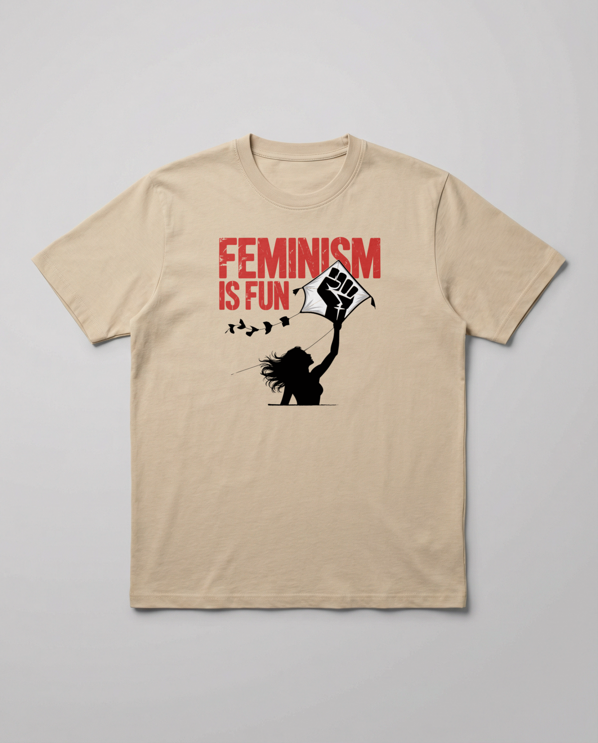 gravisk Feminism Is Fun organic graphic tee. A leaping woman flying a raised-fist kite, red FEMINISM IS FUN type.