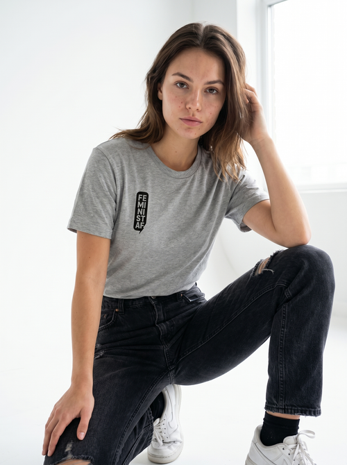 gravisk Feminist organic graphic tee. FEMINIST AF stacked in two-letter pairs, small left-chest print.
