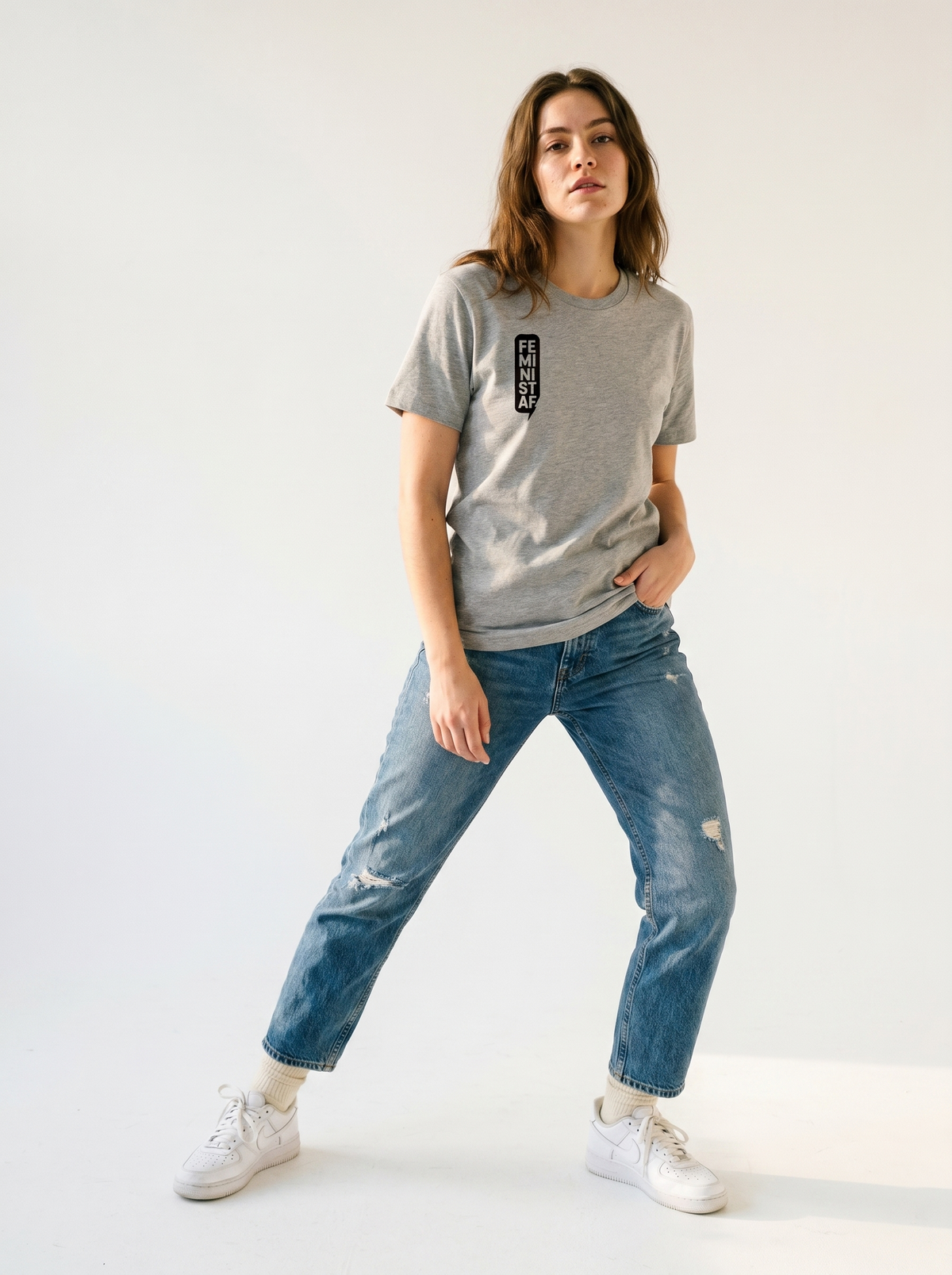 gravisk Feminist organic graphic tee. FEMINIST AF stacked in two-letter pairs, small left-chest print.