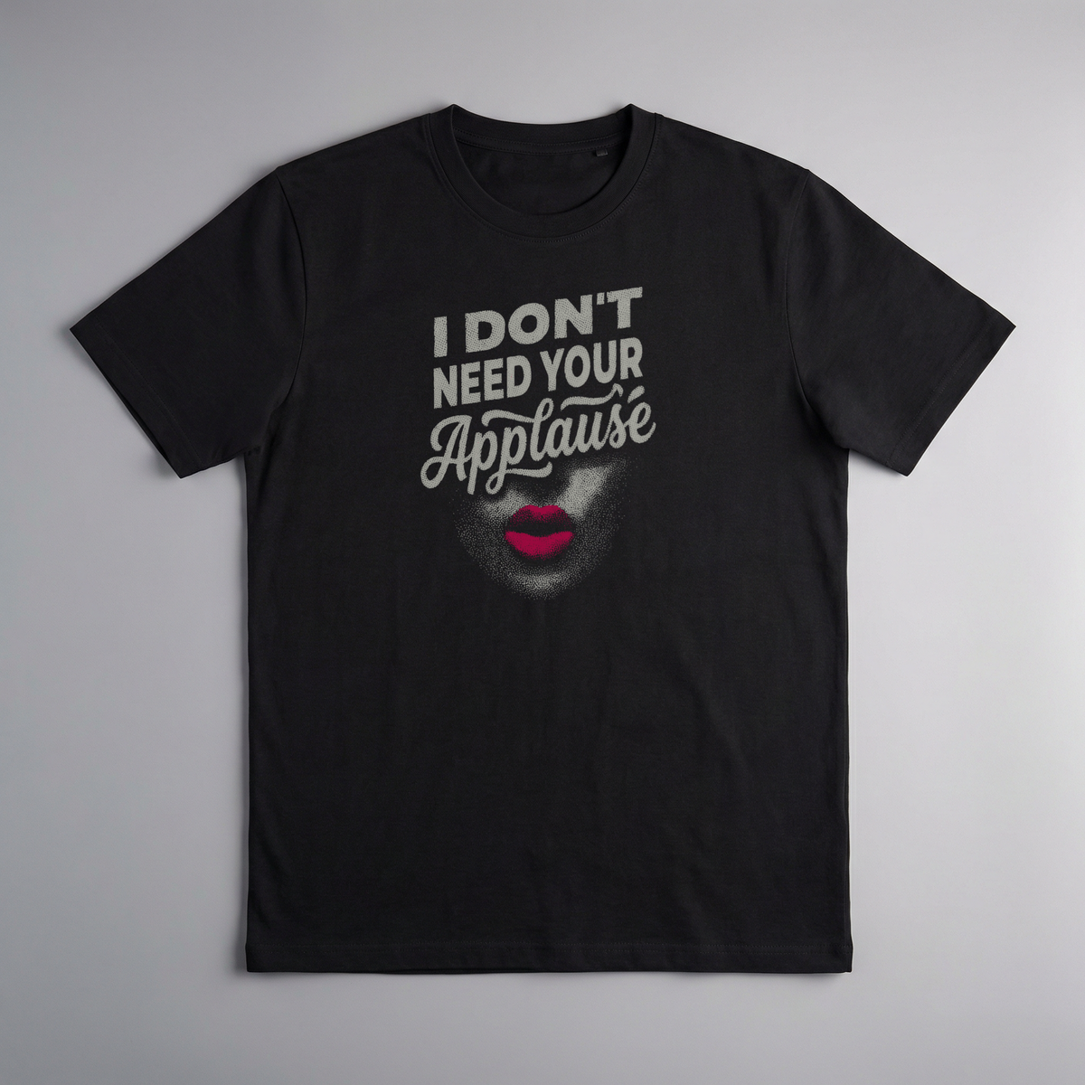 gravisk I Don't Need Your Applause organic graphic tee. A face dissolving into particles, only pink lips intact, Applause in script.