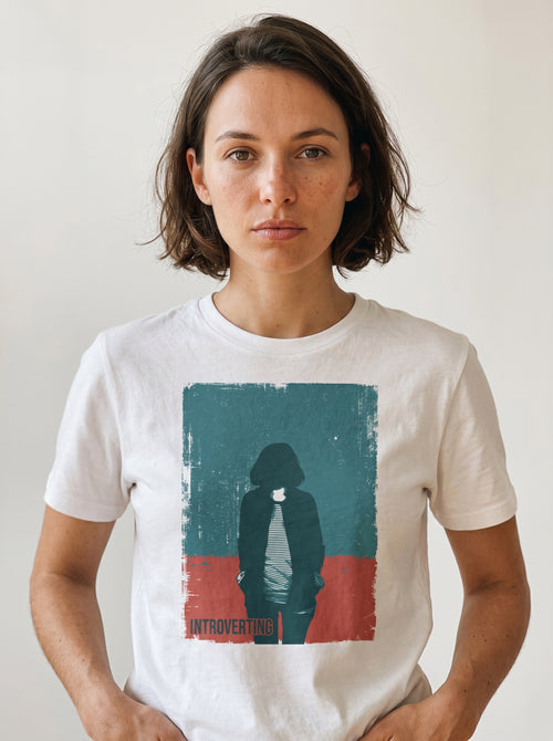 gravisk Introverting organic graphic tee. Worn teal and red poster of a faceless figure, hands in pockets, small INTROVERTING type.