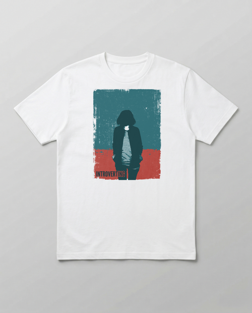 gravisk Introverting organic graphic tee. Worn teal and red poster of a faceless figure, hands in pockets, small INTROVERTING type.