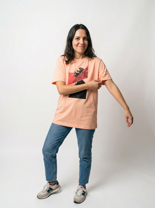 gravisk Introverting organic graphic tee. A tilted profile portrait cut by a red diagonal band reading INTROVERTING.