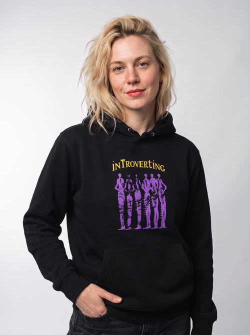 gravisk Introverting v2 graphic hoodie in organic cotton. Six tall purple figures drawn in restless strokes under yellow lettering.