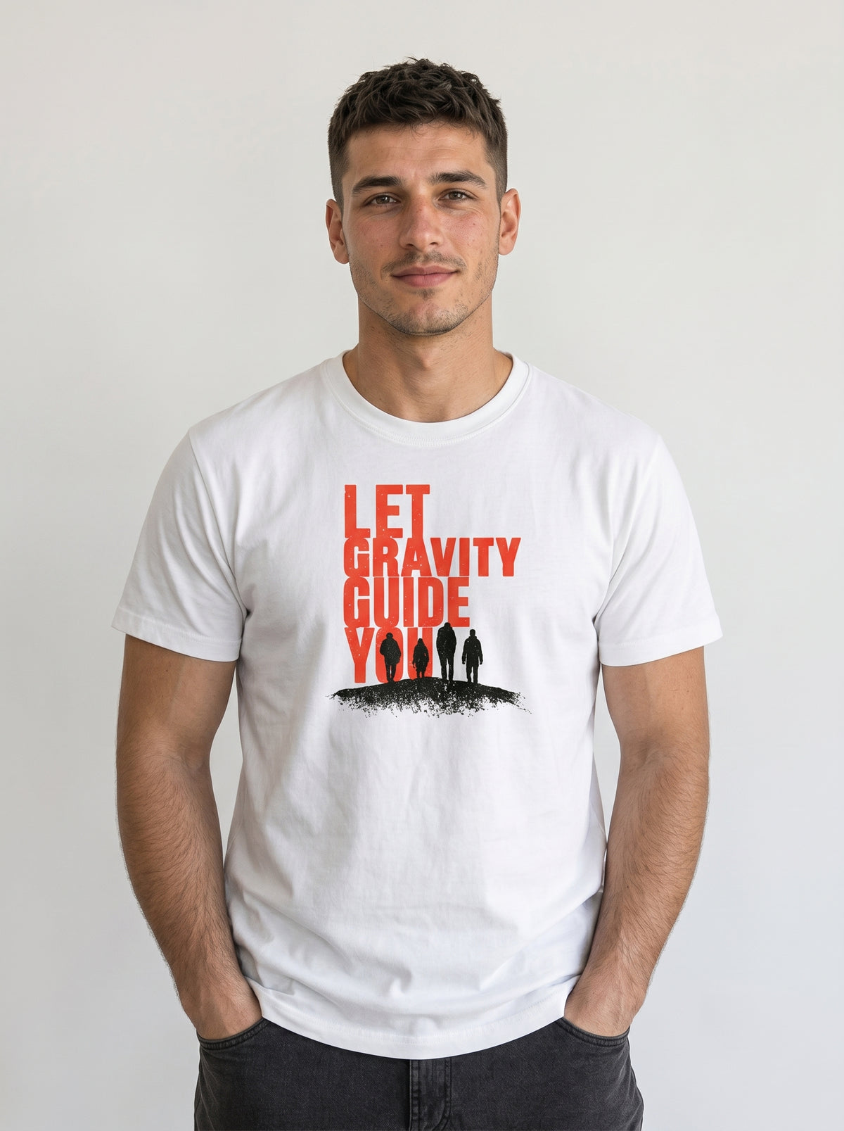 gravisk Let Gravity Guide You organic graphic tee. Stacked rust-red type over four small figures on an ink horizon.
