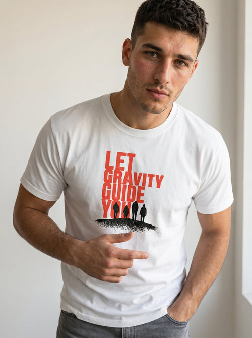 gravisk Let Gravity Guide You organic graphic tee. Stacked rust-red type over four small figures on an ink horizon.