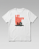 gravisk Let Gravity Guide You organic graphic tee. Stacked rust-red type over four small figures on an ink horizon.