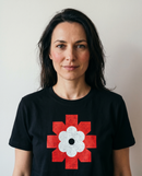 gravisk Lichen Bloom organic graphic tee. Bold red geometric emblem framing a white flower.