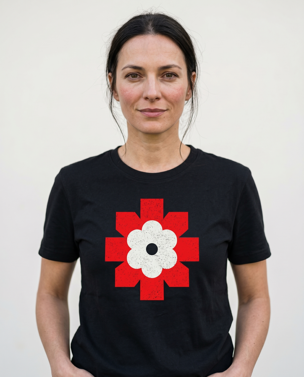 gravisk Lichen Bloom organic graphic tee. Bold red geometric emblem framing a white flower.