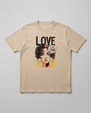 gravisk Love. I Am Strong organic graphic tee. Comic-style portrait with an I AM STRONG speech bubble, LOVE above.