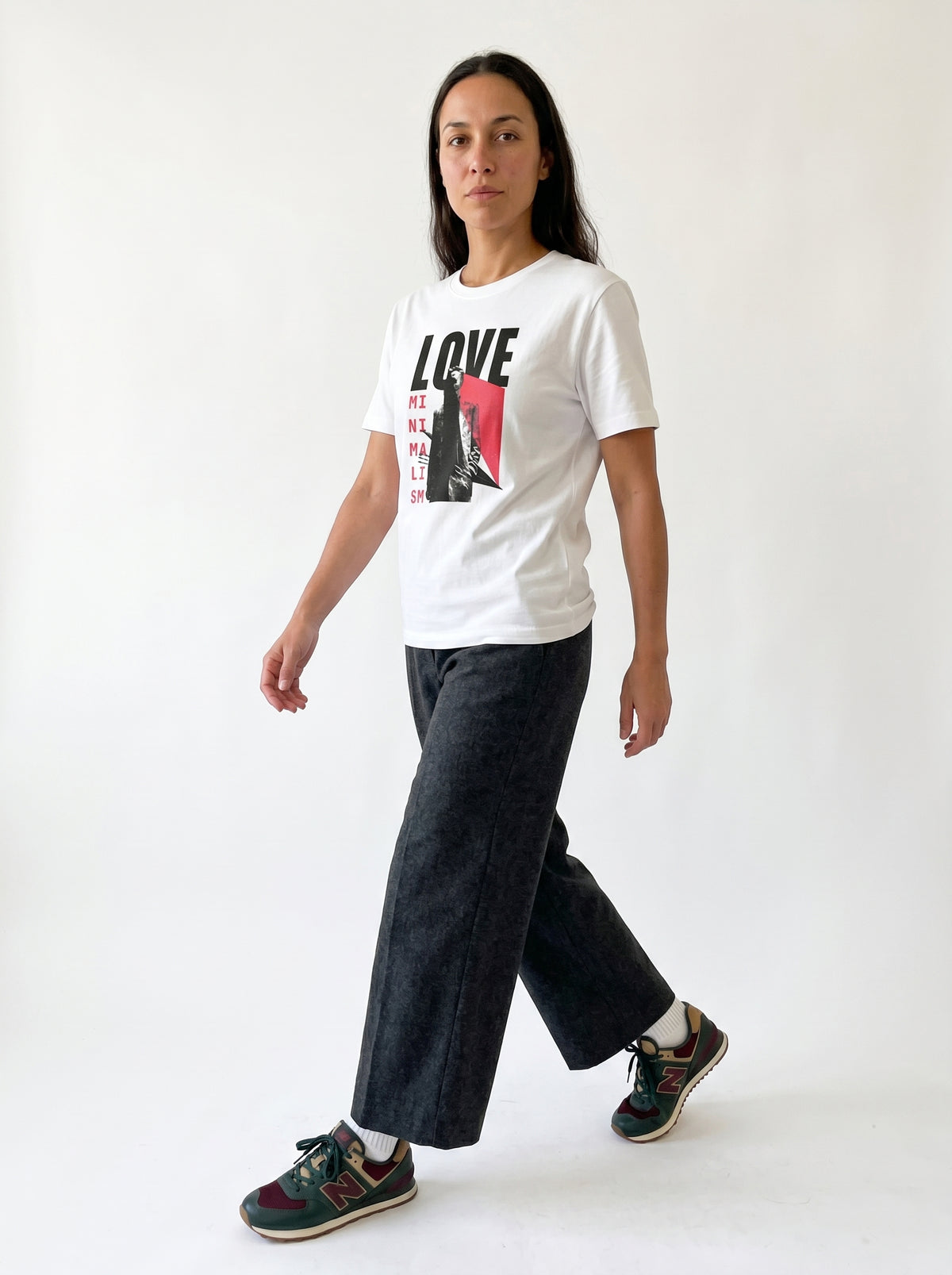 gravisk Love Minimalism organic graphic tee. LOVE in block type, MINIMALISM in a vertical column beside a reaching figure.