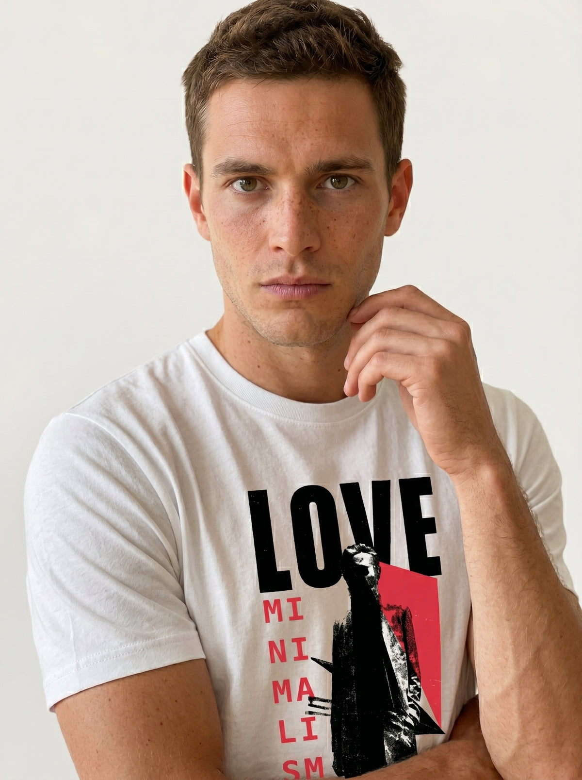 gravisk Love Minimalism organic graphic tee. LOVE in block type, MINIMALISM in a vertical column beside a reaching figure.