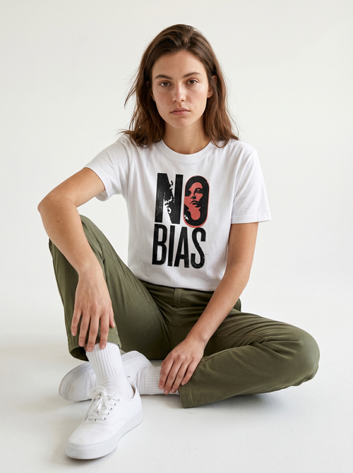 gravisk No Bias organic graphic tee. Heavy serif NO BIAS with a terracotta portrait inside the letter O.