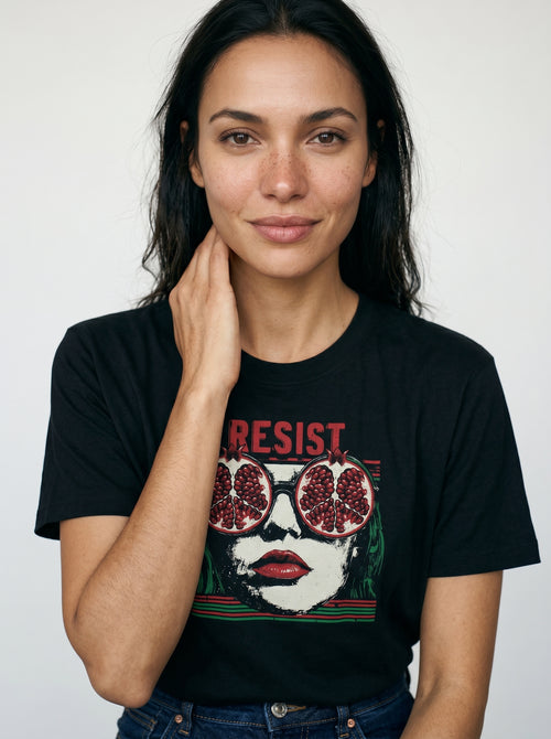 gravisk Resist organic graphic tee. Pop-art portrait with pomegranate lenses, distressed red RESIST above.