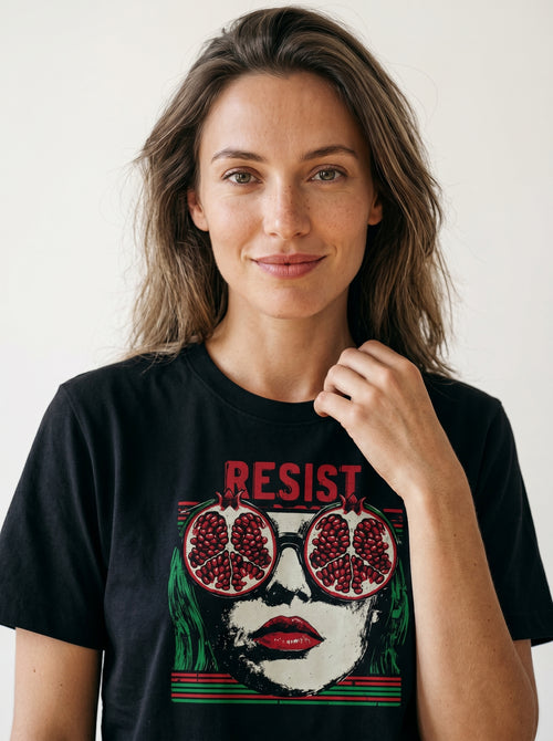 gravisk Resist organic graphic tee. Pop-art portrait with pomegranate lenses, distressed red RESIST above.