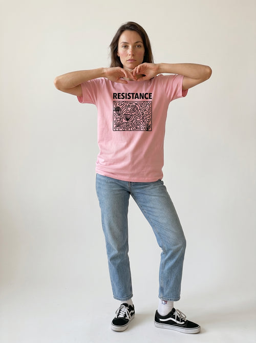 gravisk Resistance organic graphic tee. Hand-drawn panel of plants, faces and symbols in black line work, RESISTANCE above.